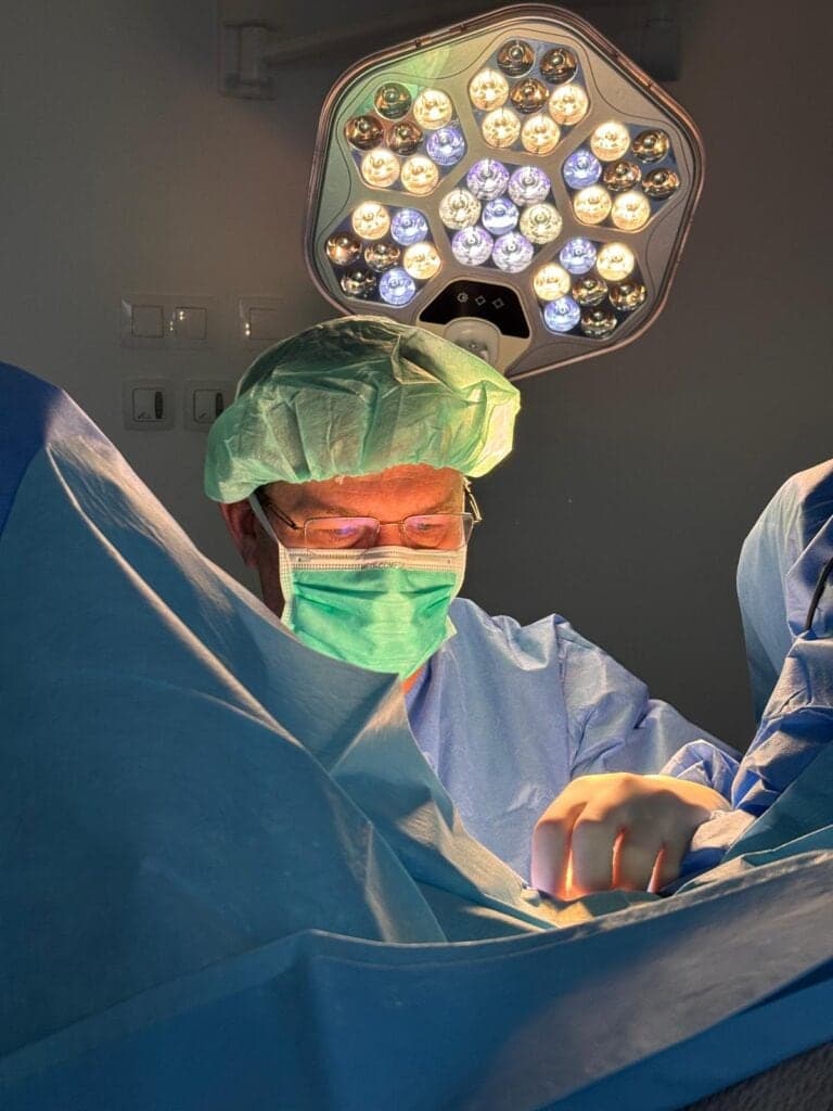 A surgeon during an operation under the surgical light
